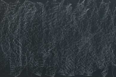 Photo of Dirty black chalkboard as background. School equipment