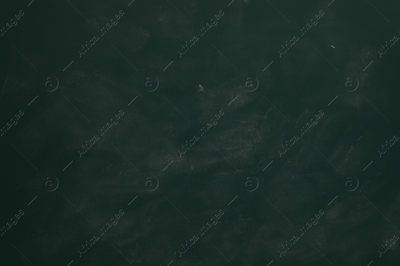 Photo of Chalk rubbed out on green chalkboard as background, closeup. Space for text