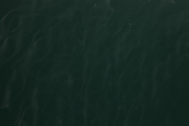Photo of Chalk rubbed out on green chalkboard as background, closeup. Space for text
