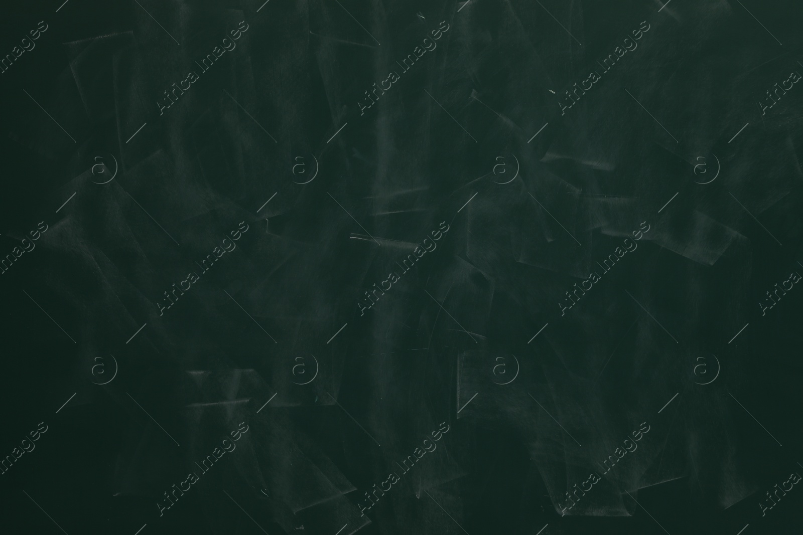 Photo of Chalk rubbed out on green chalkboard as background, closeup. Space for text