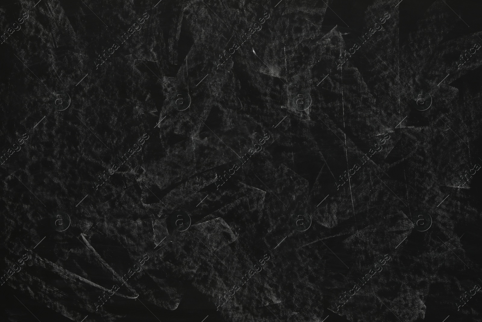 Photo of Chalk rubbed out on black chalkboard as background, closeup. Space for text