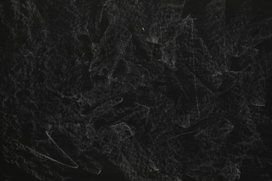 Photo of Chalk rubbed out on black chalkboard as background, closeup. Space for text