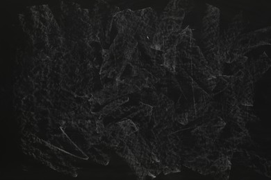 Photo of Chalk rubbed out on black chalkboard as background, closeup. Space for text