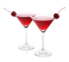 Photo of Martini cocktail with cherries in glasses on white background