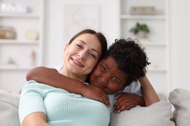 Photo of Adoption. Mother and her son at home