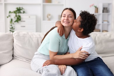 Photo of Adoption. Mother and her son at home