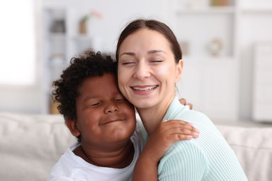 Photo of Adoption. Mother and her son at home