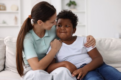 Photo of Adoption. Mother and her son at home