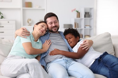 Photo of Adoption. Happy parents and their son at home