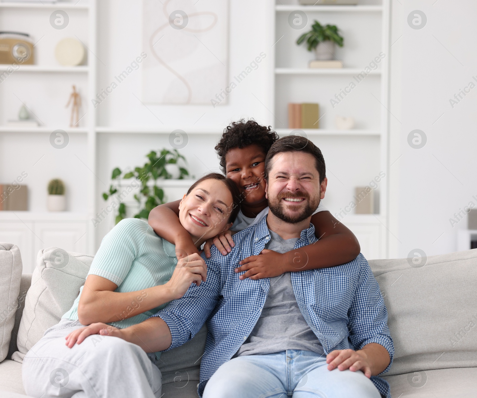 Photo of Adoption. Happy parents and their son at home