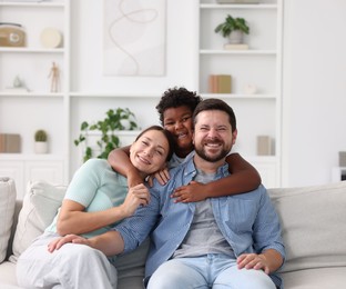 Photo of Adoption. Happy parents and their son at home