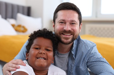 Photo of Adoption. Father and his son at home