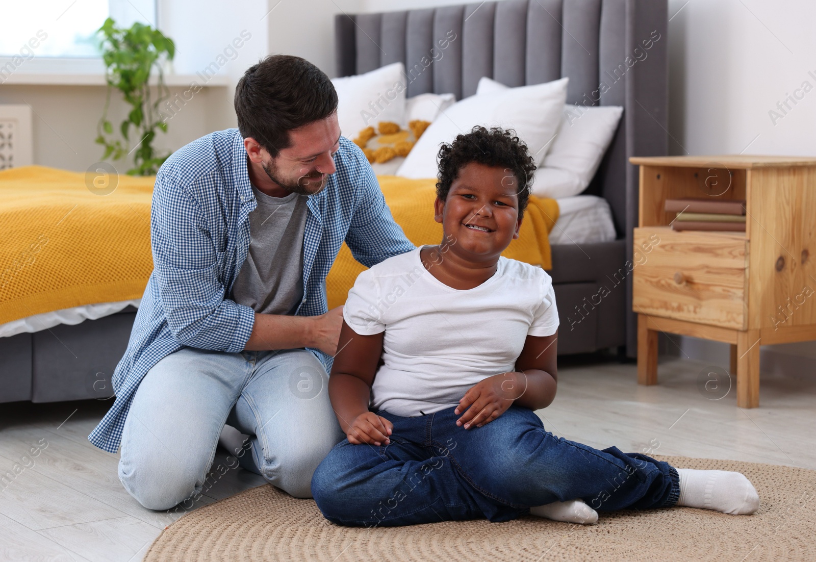 Adoption. Father and his son on floor at home Photo of Adoption. Father and his son on floor at home