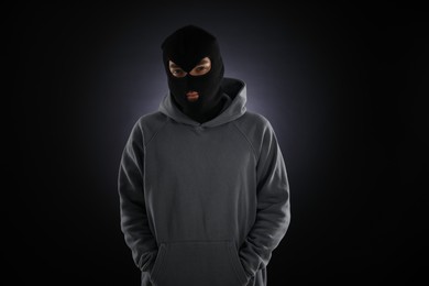 Photo of Criminal man in mask on dark background