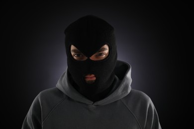 Photo of Criminal man in mask on dark background