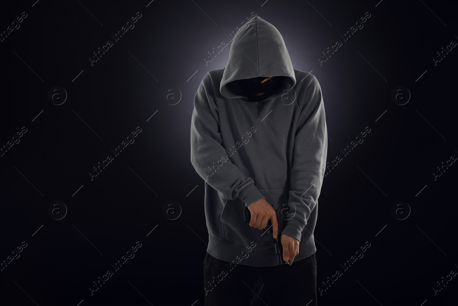 Criminal in mask with gun on dark background. Space for text Photo of Criminal in mask with gun on dark background. Space for text
