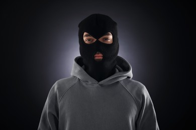 Photo of Criminal man in mask on dark background