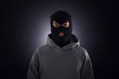 Photo of Criminal man in mask on dark background