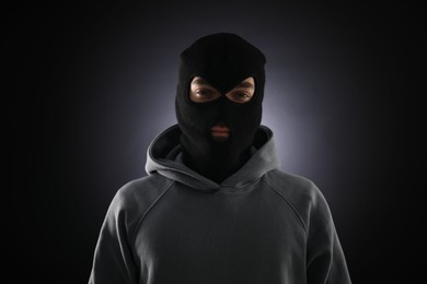 Photo of Criminal man in mask on dark background