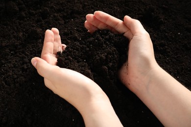 Photo of Woman with pile of fresh soil, closeup