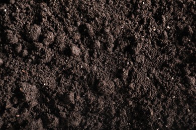Photo of Fresh soil as background, top view. Organic matter