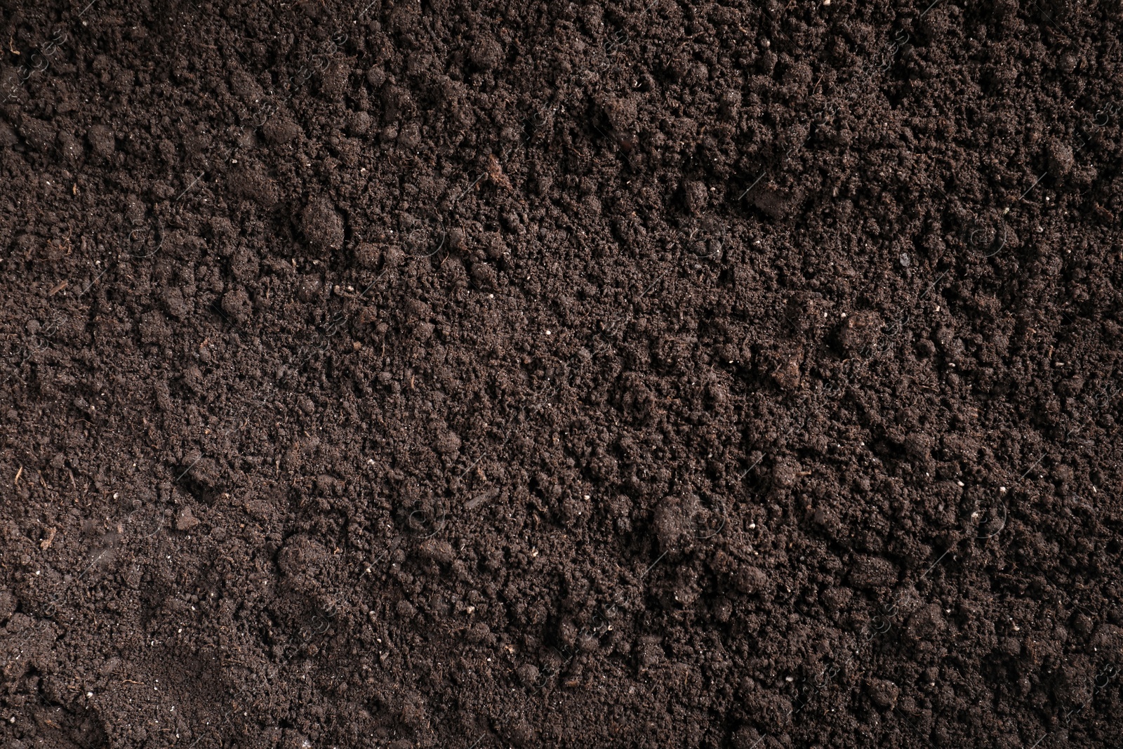 Photo of Fresh soil as background, top view. Organic matter