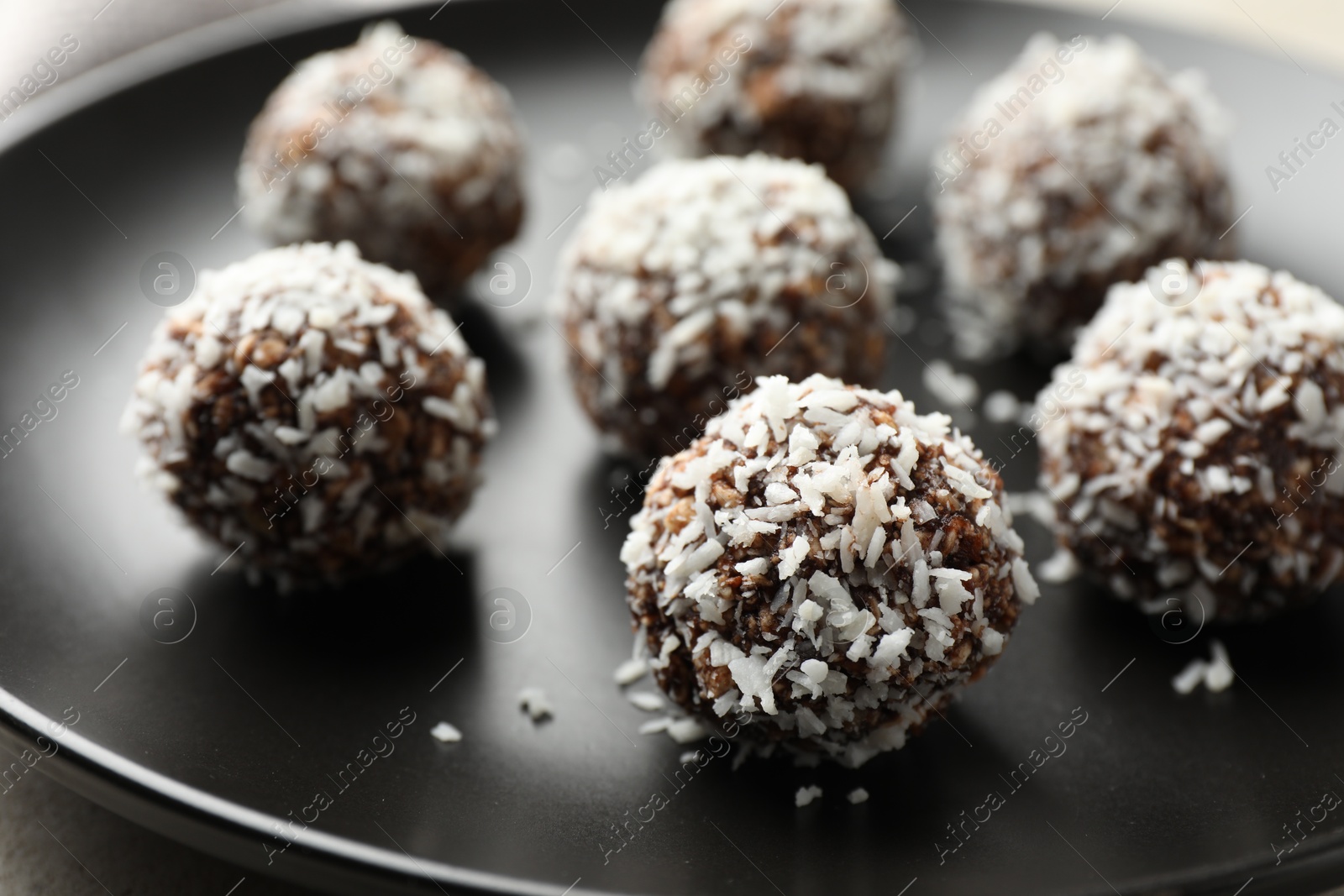 Tasty chocolate candies with nuts on light table, closeup Photo of Tasty chocolate candies with nuts on light table, closeup