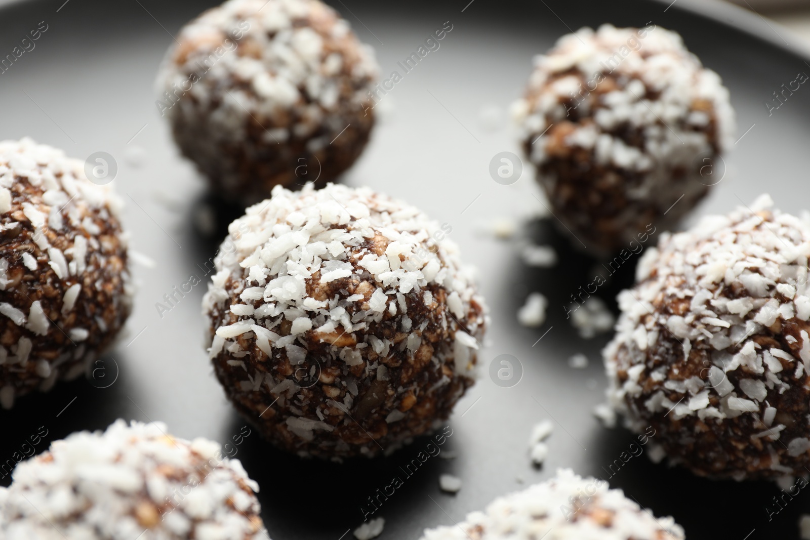 Tasty chocolate candies with nuts on plate, closeup Photo of Tasty chocolate candies with nuts on plate, closeup