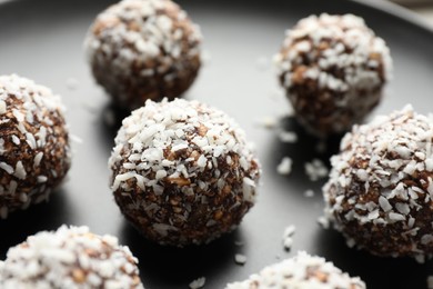 Photo of Tasty chocolate candies with nuts on plate, closeup