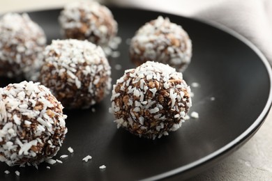 Photo of Tasty chocolate candies with nuts on light table, closeup