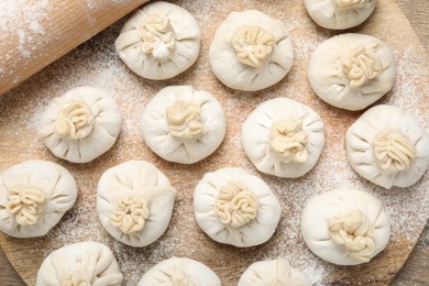 Photo of Uncooked khinkalis (dumplings) on table, top view