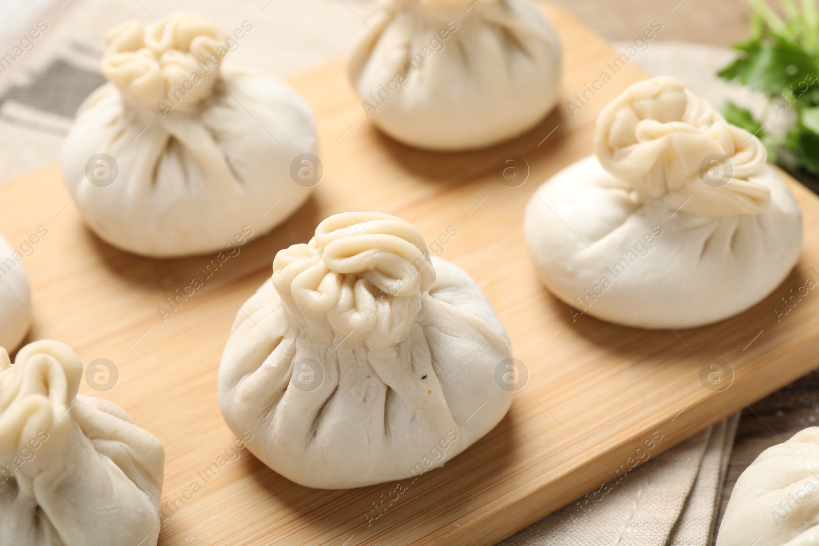 Many uncooked khinkalis (dumplings) on table, closeup Photo of Many uncooked khinkalis (dumplings) on table, closeup