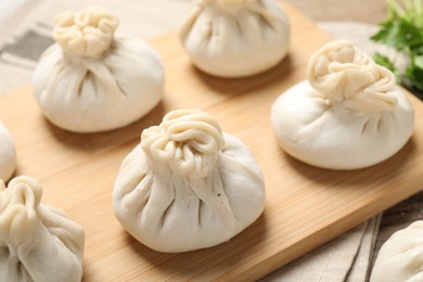 Photo of Many uncooked khinkalis (dumplings) on table, closeup