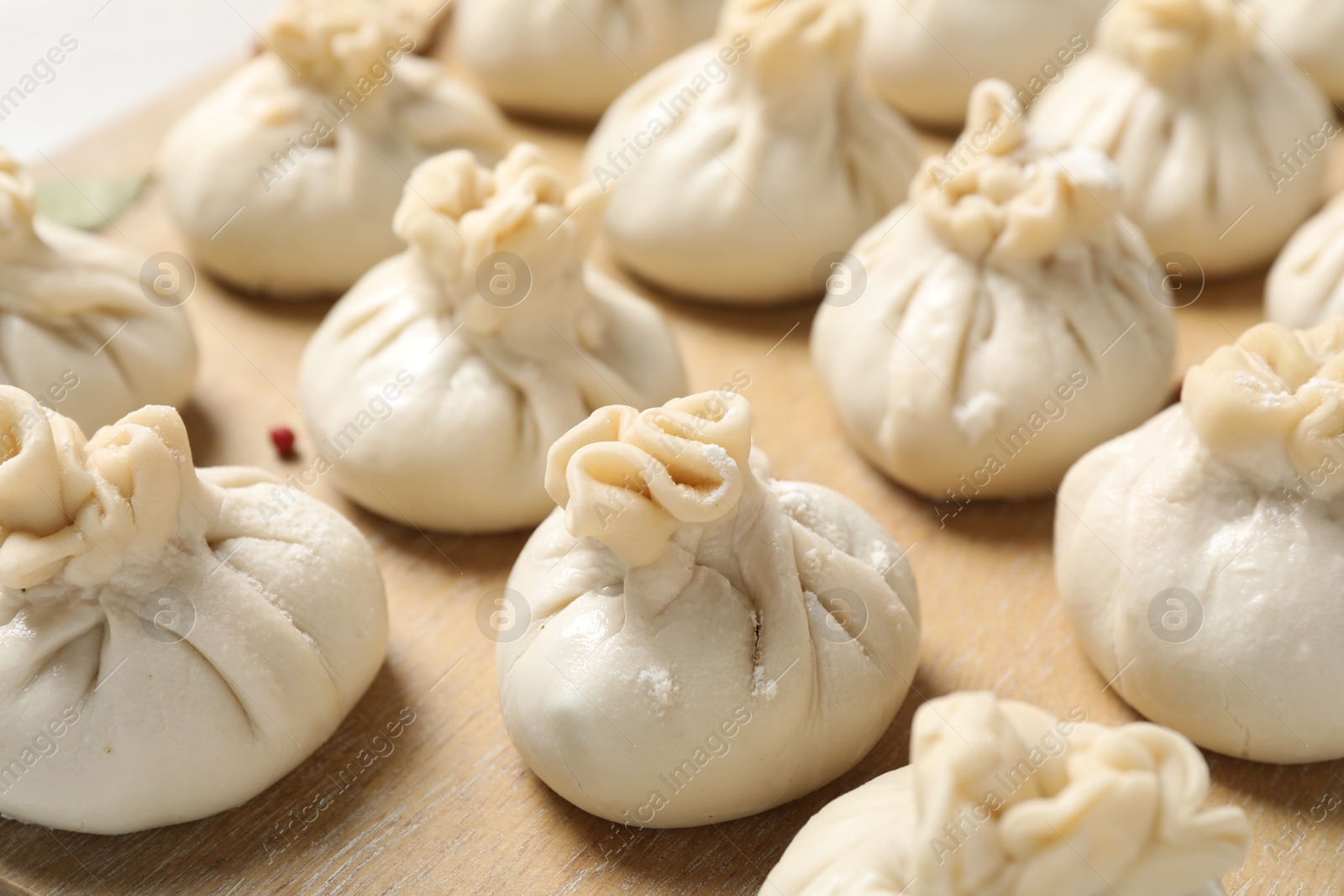 Many uncooked khinkalis (dumplings) on table, closeup Photo of Many uncooked khinkalis (dumplings) on table, closeup