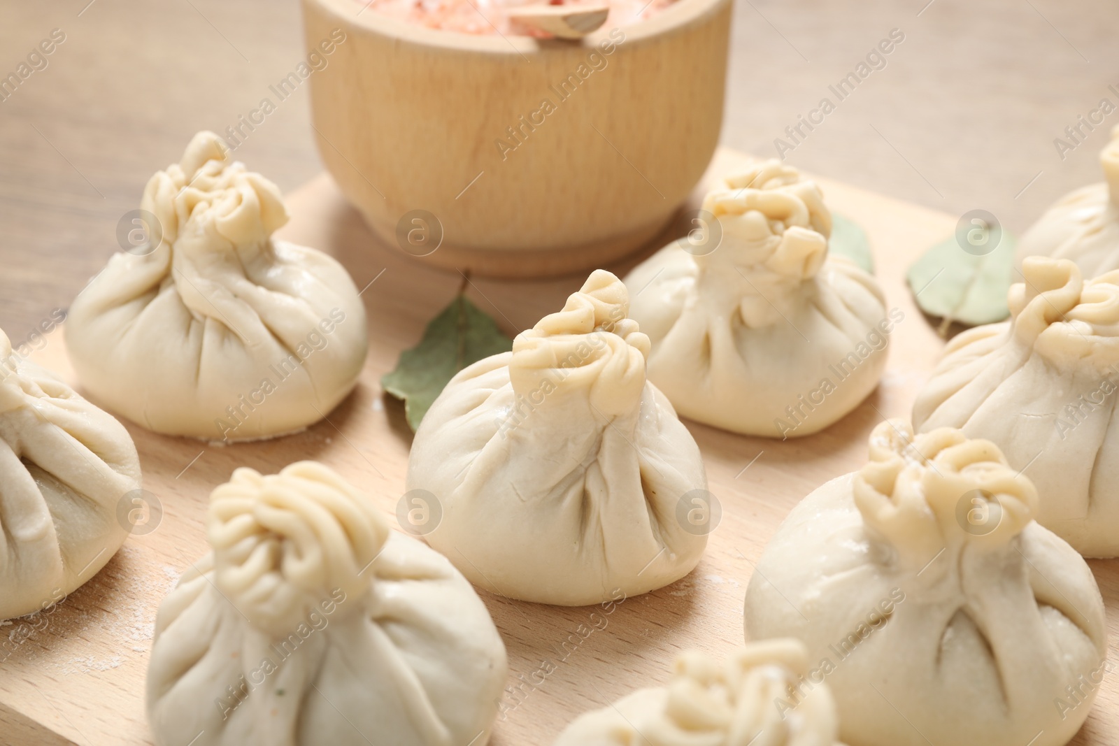 Uncooked khinkalis (dumplings) and spices on table, closeup Photo of Uncooked khinkalis (dumplings) and spices on table, closeup