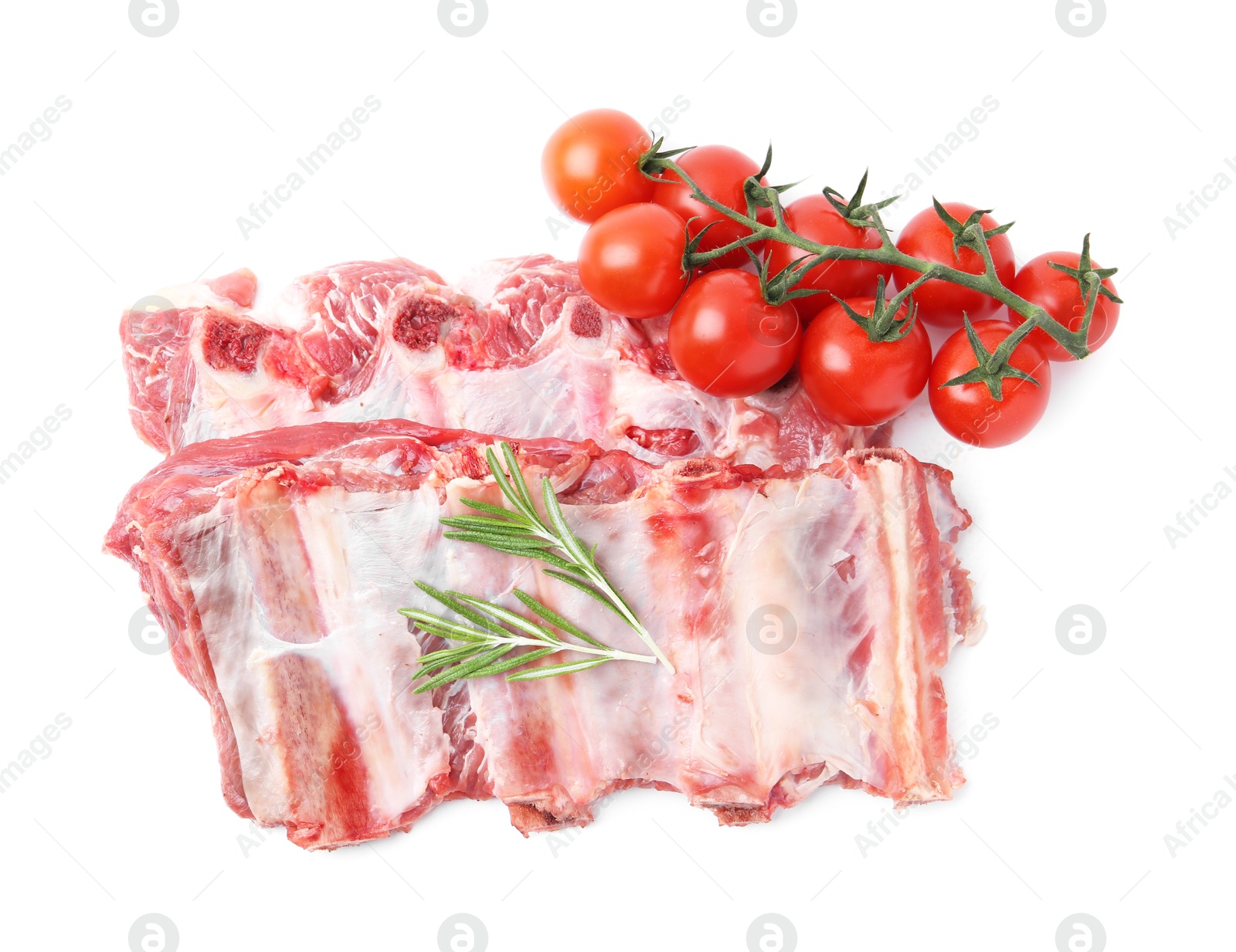 Fresh raw beef ribs, tomatoes and rosemary isolated on white, top view Photo of Fresh raw beef ribs, tomatoes and rosemary isolated on white, top view