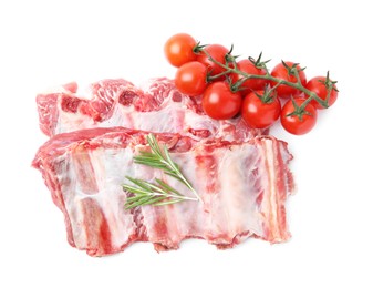 Photo of Fresh raw beef ribs, tomatoes and rosemary isolated on white, top view