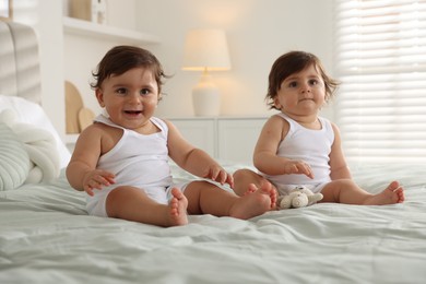 Photo of Cute little twin babies on bed at home