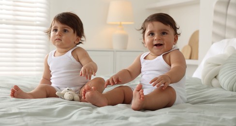 Photo of Cute little twin babies on bed at home