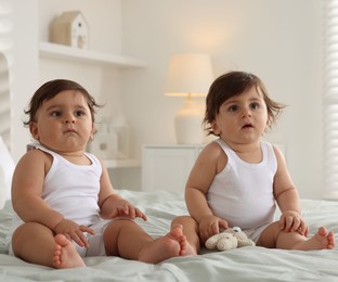 Photo of Cute little twin babies on bed at home