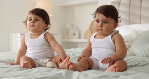 Photo of Cute little twin babies on bed at home