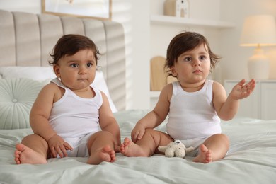 Photo of Cute little twin babies on bed at home