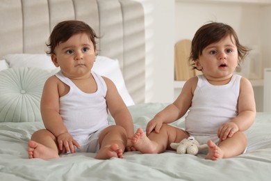 Photo of Cute little twin babies on bed at home