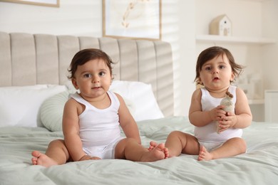 Photo of Cute little twin babies on bed at home