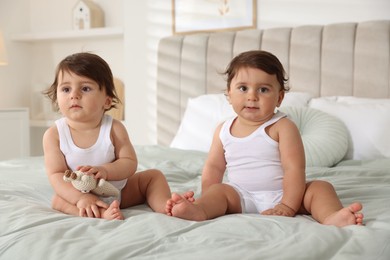 Photo of Cute little twin babies on bed at home
