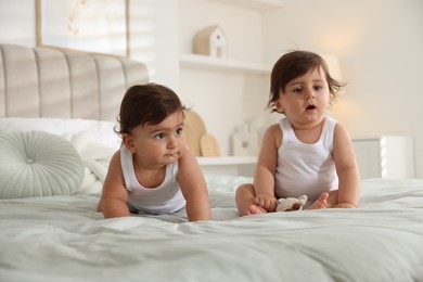 Photo of Cute little twin babies on bed at home