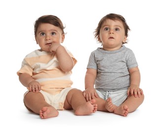 Photo of Cute little twin babies on white background