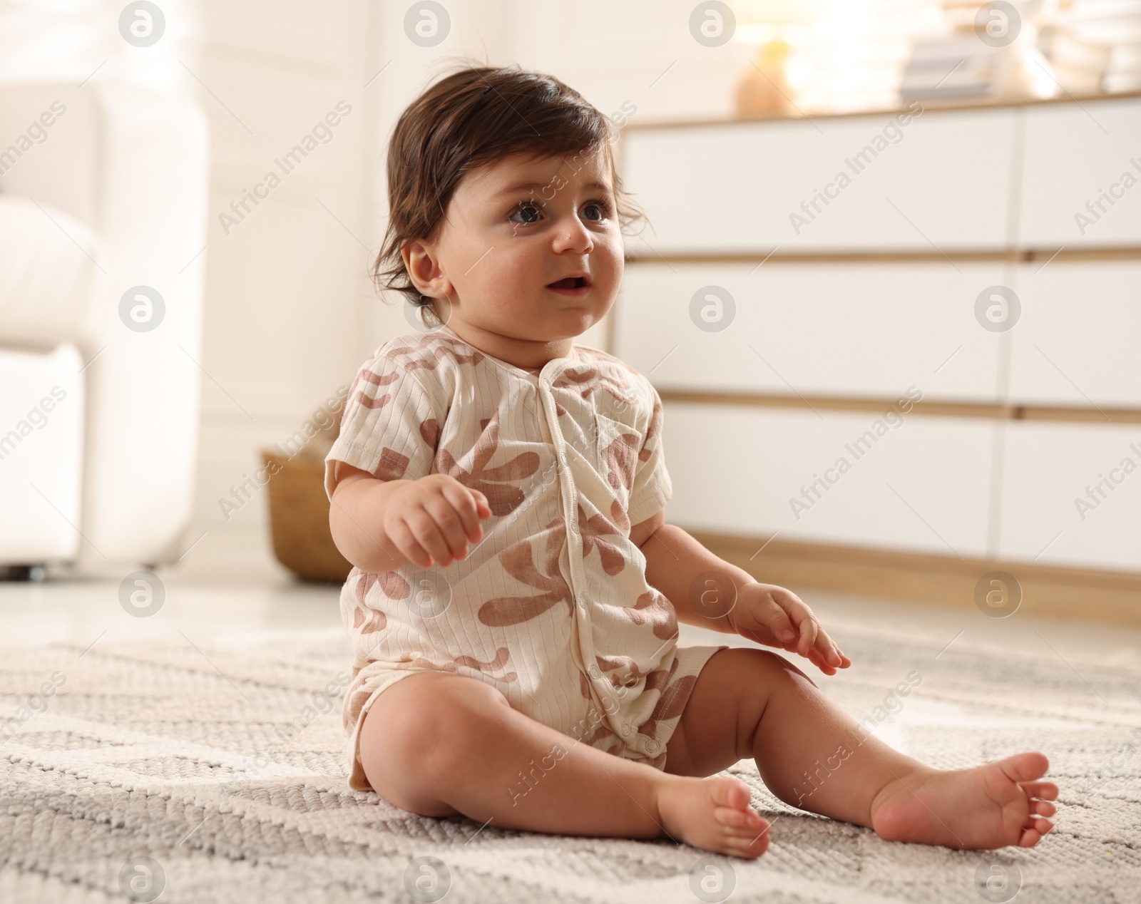 Cute little baby on floor at home Photo of Cute little baby on floor at home