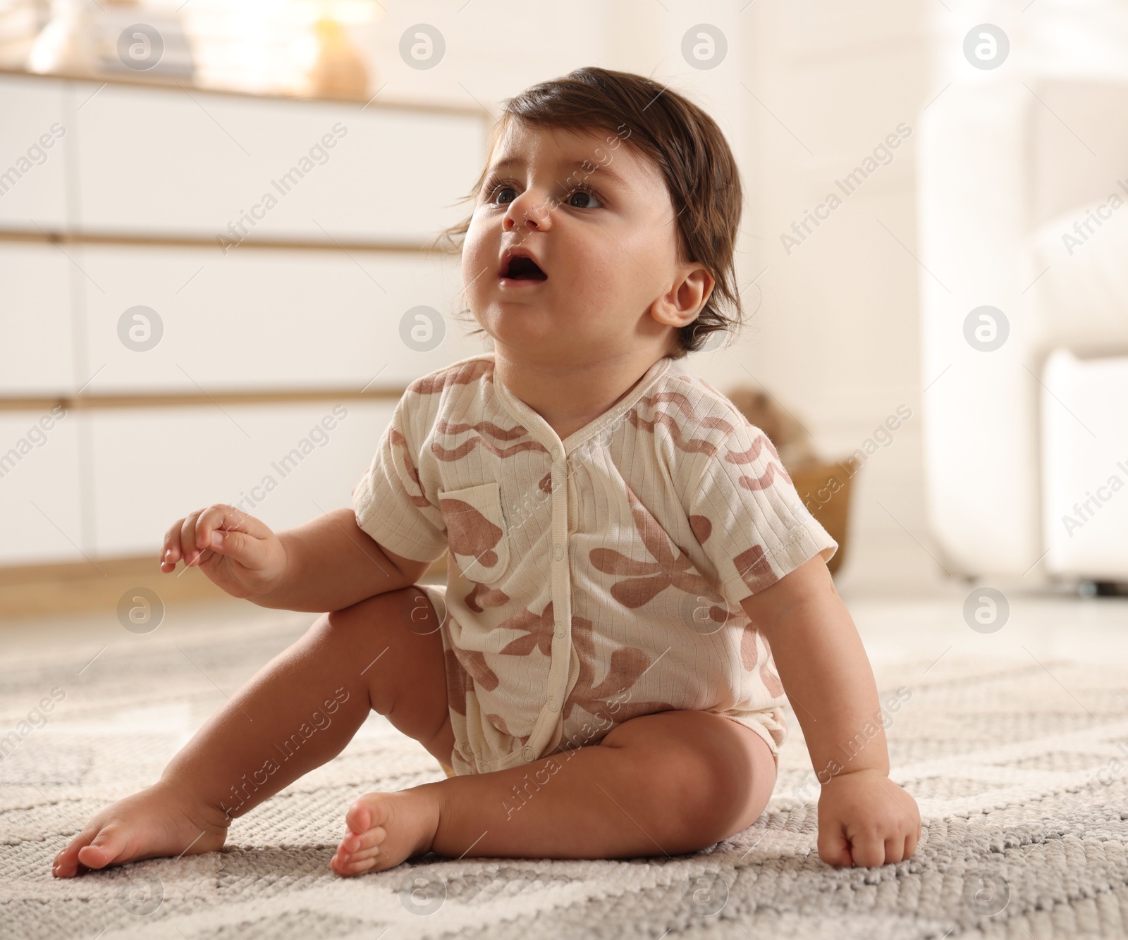 Cute little baby on floor at home Photo of Cute little baby on floor at home