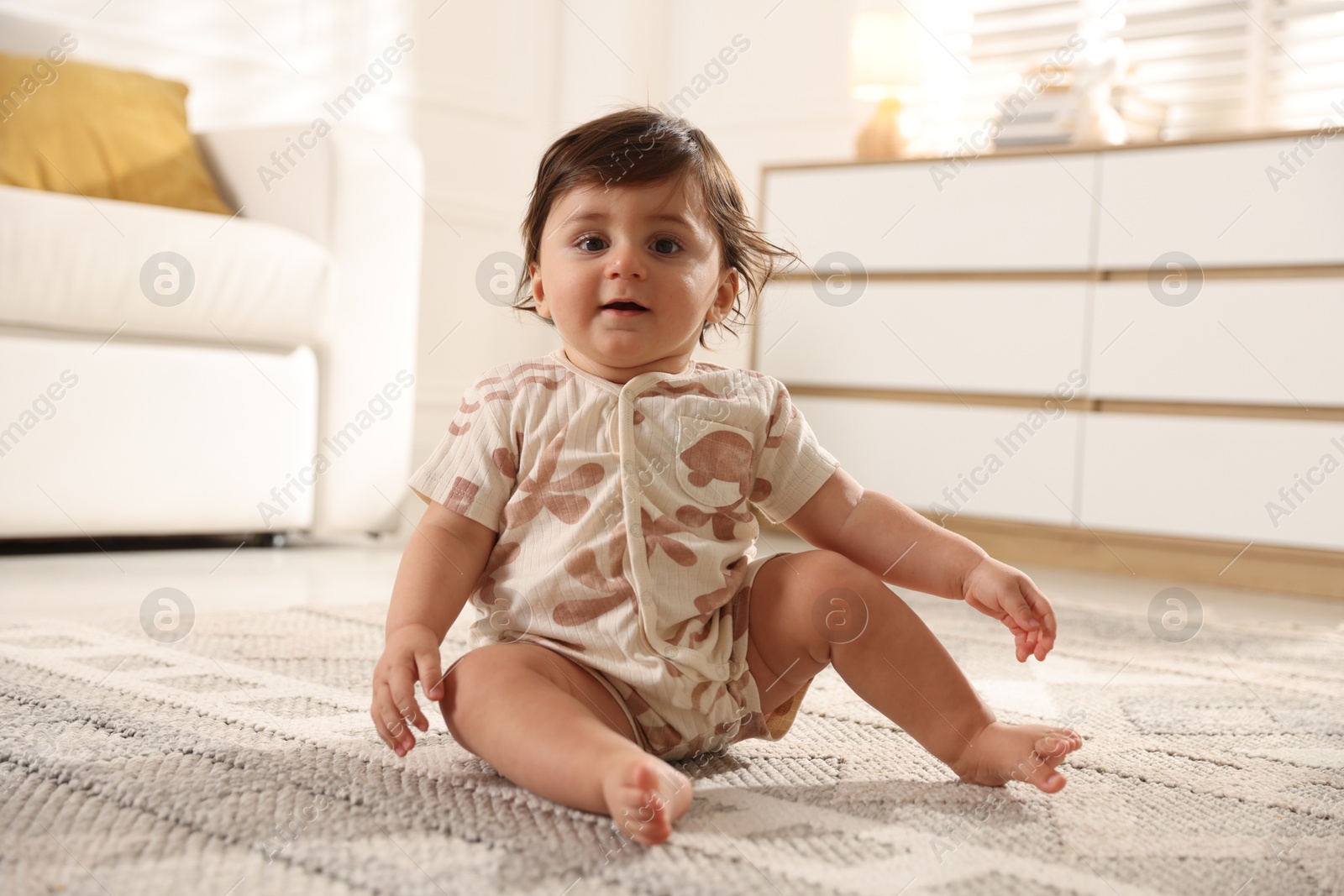 Cute little baby on floor at home Photo of Cute little baby on floor at home